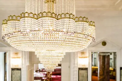 a large chandelier in a room with mirrors at Grand Hotel Bellevue - adults only in Merano