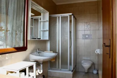 a bathroom with a sink and a toilet at Gruberhof in Postal