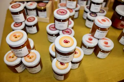 a group of bottles of honey on a table at Gruberhof in Postal
