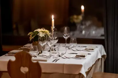 a table with wine glasses and a candle on it at Sporthotel Teresa in Badia