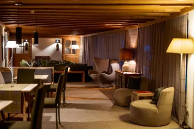a lobby with chairs and tables and a living room at Sporthotel Teresa in Badia