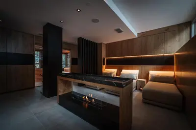 a hotel room with a bed and a fireplace at Sporthotel Teresa in Badia