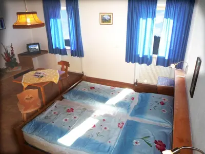 a bedroom with a bed and a table in it at Apartments Ingrid in La Valle