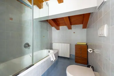 a bathroom with a tub and a toilet and a sink at Barisetti Sport Hotel in Cortina dʼAmpezzo