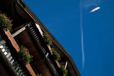 a kite flying in the sky over a building at Hotel Medil in Campitello di Fassa