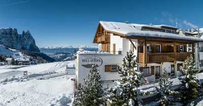 a building on top of a snow covered mountain at Hotel Bellavista in Alpe di Siusi