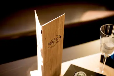 a wooden box sitting on a table next to a glass at Hotel Bellavista in Alpe di Siusi