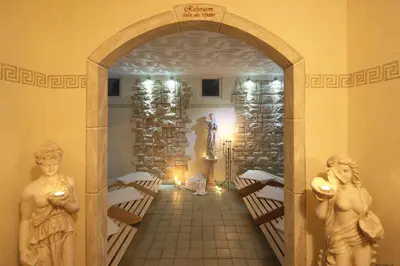 an archway in a room with statues of people at Hotel Bellavista in Alpe di Siusi