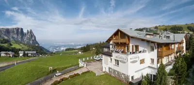 an aerial view of a house in the mountains at Hotel Bellavista in Alpe di Siusi