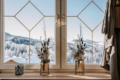 two vases sitting on a window sill with a view at Hotel Obereggen in Obereggen