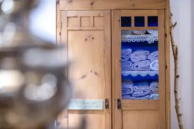 a wooden door with a bunch of blue dishes at Hotel Alpino in Varena