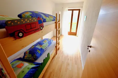 two bunk beds in a room with a fire truck bedroom at Agriturismo Reinhof in San Felice