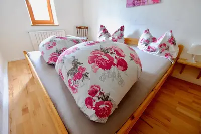 a bed with pink and white sheets and pillows at Agriturismo Reinhof in San Felice