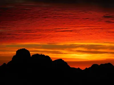 a sunset in the mountains with a red sky at Hotel Al Viel B&B in Canazei