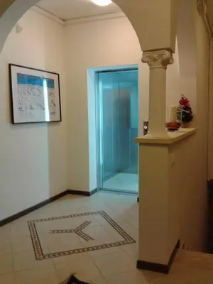 a hallway with a glass shower in a building at Hotel Bucaneve in Moena