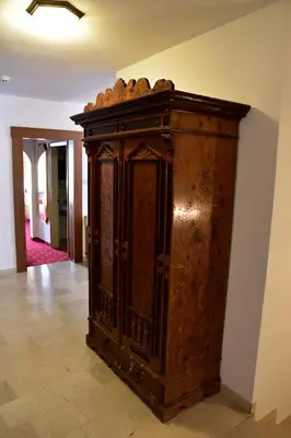 a wooden cabinet sitting on a floor in a room at Hotel Krone in Brunico