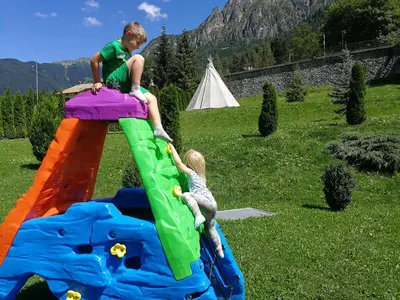 a boy and a girl playing on a inflatable play set at Rio Stava Family Resort & Spa in Tesero