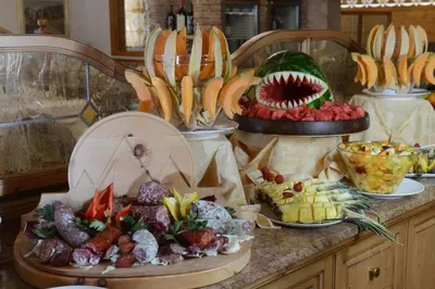 a buffet of different types of food on a counter at Rio Stava Family Resort & Spa in Tesero