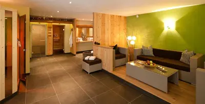 a living room with a couch and a table at Hotel Falken in Falzes
