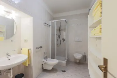 a bathroom with a shower and a sink and a toilet at Residence Hof am Keller in Montagna