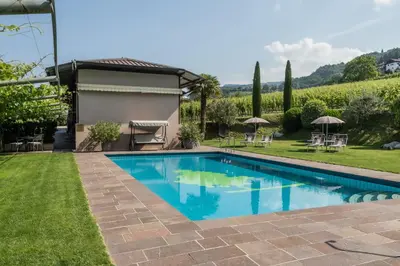 a swimming pool in the yard of a house at Residence Hof am Keller in Montagna