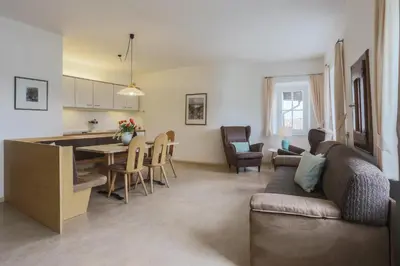 a kitchen and dining room with a table and chairs at Residence Hof am Keller in Montagna