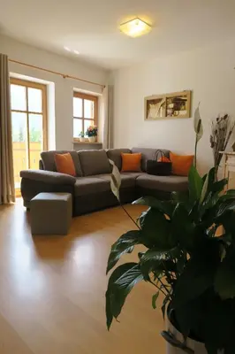 a living room with a couch and a plant at Winklerhof in Parcines