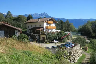 a house with a bunch of cars parked in front of it at Winklerhof in Parcines