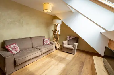 a living room with a couch and a chair at Agalma in Brunico