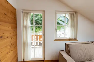 a living room with two windows and a couch at Agalma in Brunico