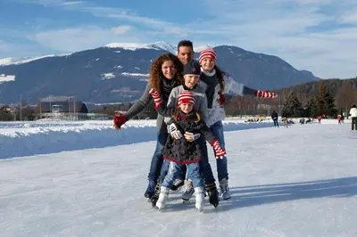 a family posing for a picture on the ice at Agalma in Brunico