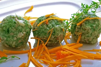 a plate of meatballs and carrots on a plate at Hotel Burgfrieden in Gais