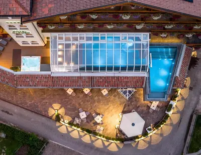 an overhead view of a swimming pool in a house at Hotel Garden in Moena