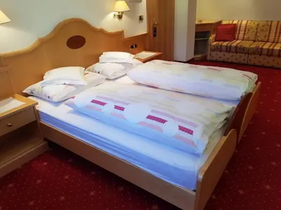 a large bed in a hotel room at Garni Rubens B&B in Selva di Val Gardena