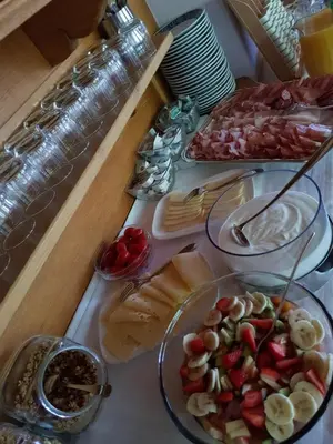 a table topped with plates of food on a table at Garni Rubens B&B in Selva di Val Gardena