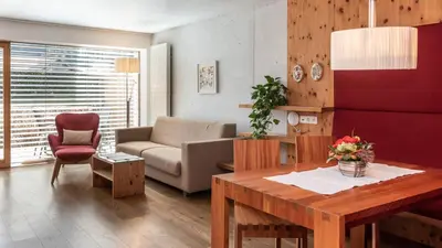 a bedroom with a bed with white sheets and pillows at Residence Tolderhof - Olang in Valdaora