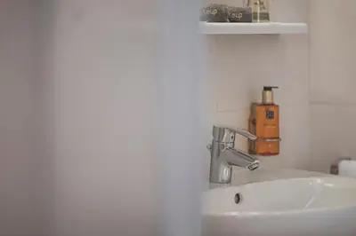 a bathroom with a sink and a faucet at Residence Chiavi D'Oro - Goldener Schlüssel in Bressanone