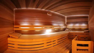 a sauna with wooden walls and wood flooring at Garni Hotel Rosengarten B&B in Selva di Val Gardena