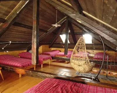 a room with a hammock in a attic at Baita Casera Caviazza in Falcade