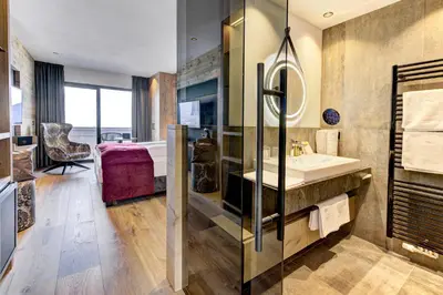 a bathroom with a sink and a tub at Hotel Bergland in Schenna