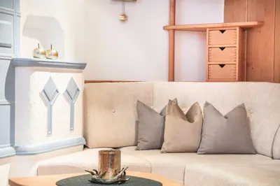 a living room with a couch with pillows on it at Arjentel Lodge in Selva di Val Gardena