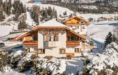 a house in the snow with snow at Arjentel Lodge in Selva di Val Gardena