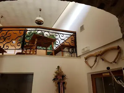 a staircase with a stained glass window in a house at Albergo Posta in Colle Santa Lucia