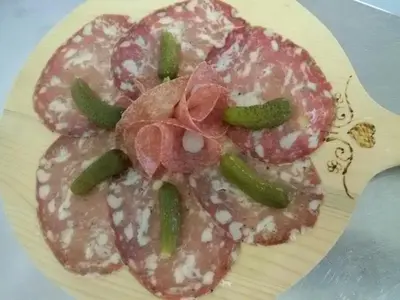 a plate of food with meat and vegetables on it at Albergo Posta in Colle Santa Lucia