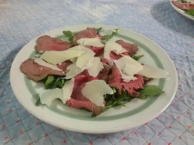 a plate of food with meat and cheese on it at Albergo Posta in Colle Santa Lucia