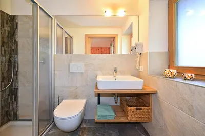 a bathroom with a sink and a toilet and a shower at Planatschhof in Villnoss