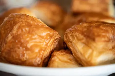 a white bowl filled with croissants at Al Piccolo Hotel in Vigo di Fassa