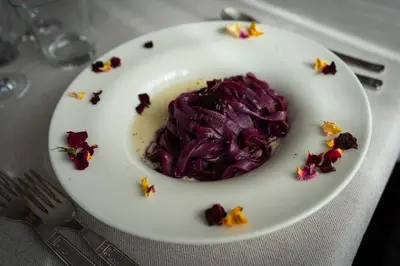 a plate of purple food on a table at Al Piccolo Hotel in Vigo di Fassa