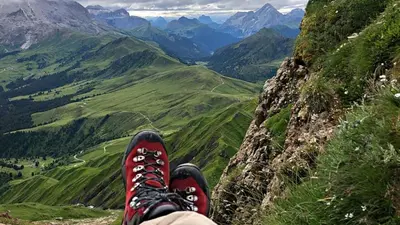a person with their feet up on a mountain at Paradiso Pure Living Vegan Hotel in Alpe di Siusi