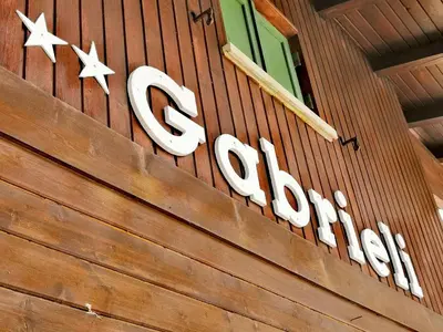 a sign on the side of a building at Garni Gabrieli in Corvara in Badia
